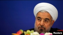 Iran's President Hassan Rouhani arrives to attend a news conference at a hotel after the fourth Conference on Interaction and Confidence Building Measures in Asia (CICA) summit, in Shanghai, May 22, 2014.