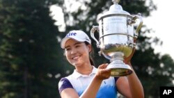 South Korea's In Gee Chun holds up the championship trophy after winning the U.S. Women's Open golf tournament at Lancaster Country Club, July 12, 2015 in Lancaster, Pennsylvania.