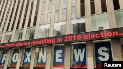 A news ticker displays headlines from the meeting of U.S. President Donald Trump and Russia's President Vladimir Putin in Helsinki, Finland on the News Corp building in New York, July 16, 2018. 