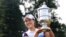 South Korea's In Gee Chun holds up the championship trophy after winning the U.S. Women's Open golf tournament at Lancaster Country Club, July 12, 2015 in Lancaster, Pennsylvania.