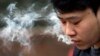 David Wang, 19, smokes outside during a break from classes at Seattle Central College in Seattle, Washington, Jan. 7, 2016.