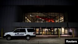 A police car is seen at a closed terminal before the arrival of an aircraft bringing government employees and other Americans from the coronavirus threat in Wuhan, China, at an airport in Anchorage, Alaska, Jan. 28, 2020. 