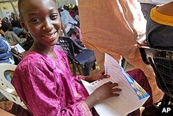 A student at the event reads over the rights of the child