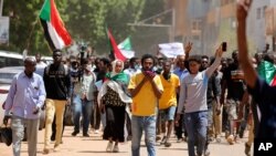 FILE - Sudanese protesters, pressuring transitional authorities for more reforms, march to the Cabinet’s headquarters in the capital, Khartoum, Sudan, Aug. 17, 2020. 