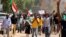 FILE - Sudanese protesters, pressuring transitional authorities for more reforms, march to the Cabinet’s headquarters in the capital, Khartoum, Sudan, Aug. 17, 2020. 