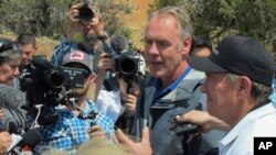 Interior Secretary Ryan Zinke, second from right, is joined by Utah Gov. Gary Herbert, right, during a press conference, May 8, 2017, at the Butler Wash trailhead within Bears Ears National Monument near Blanding, Utah.