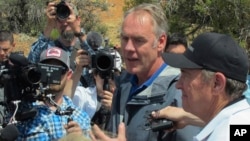 Interior Secretary Ryan Zinke, second from right, is joined by Utah Gov. Gary Herbert, right, during a press conference, May 8, 2017, at the Butler Wash trailhead within Bears Ears National Monument near Blanding, Utah.