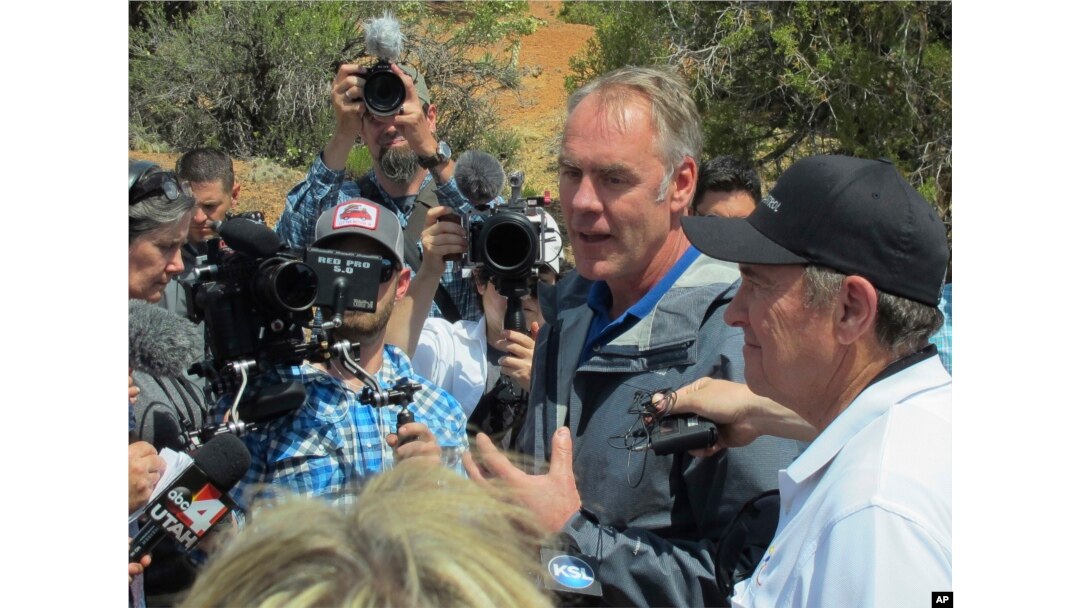 FILE - Interior Secretary Ryan Zinke, second from right, speaks during a press conference near Blanding, Utah, May 8, 2017.