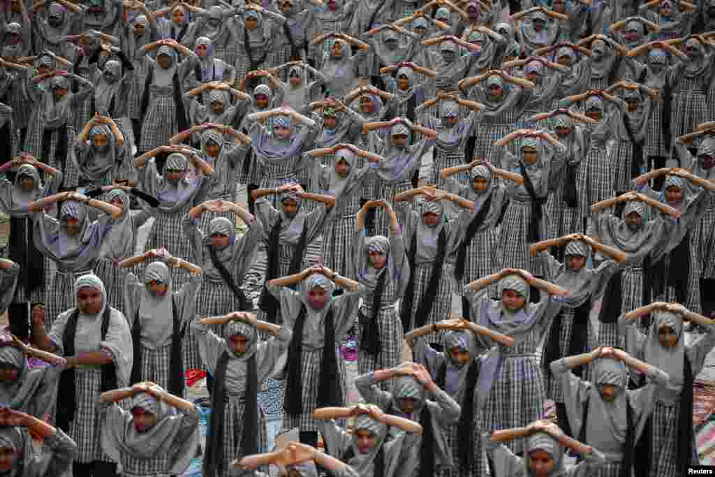 Muslim students attend a yoga lesson at a school ahead of International Yoga Day in Ahmedabad, India.