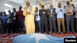 Religious leaders and journalists attend prayers before a funeral for Abdiaziz Mohamud Guled who worked with the government-owned Radio Mogadishu and was killed in a suicide attack, in Mogadishu, Nov. 21, 2021.