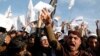 FILE - In a protest earlier this year at Afghanistan's Nangarhar University, students chant slogans critical of the satirical French weekly Charlie Hebdo, which had featured a cartoon of the Prophet Muhammad on its cover, Jan. 18, 2015.