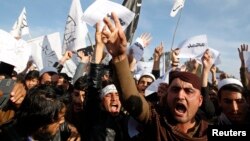 FILE - In a protest earlier this year at Afghanistan's Nangarhar University, students chant slogans critical of the satirical French weekly Charlie Hebdo, which had featured a cartoon of the Prophet Muhammad on its cover, Jan. 18, 2015.