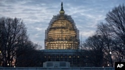 The Capitol Dome in Washington is illuminated early, Jan. 12, 2016, as President Barack Obama prepares to deliver his final State of the Union address before Congress.