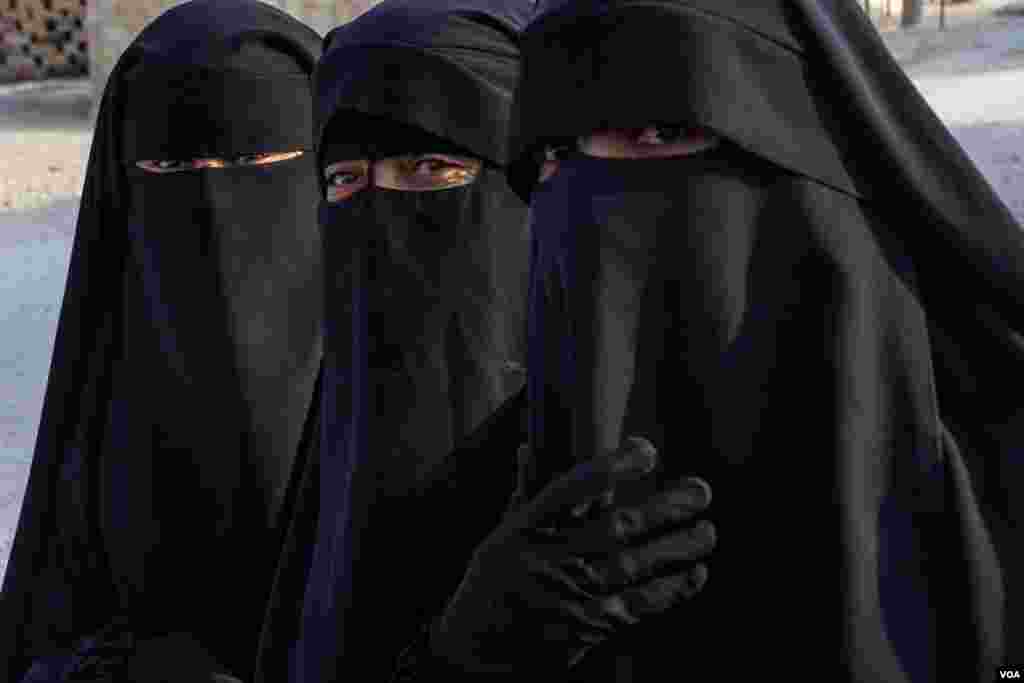 Three women from Iraq keep their niqabs inside al-Hol Camp, the largest detention center for people accused of being part of IS in Northeast Syria, on Oct. 12, 2024. (Diego Baravelli/VOA) 