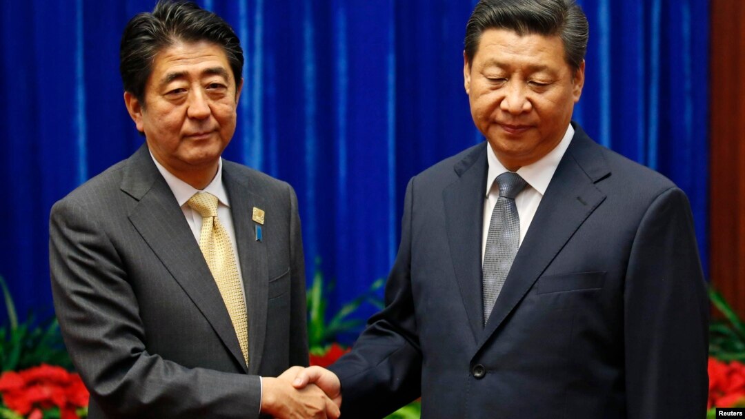 China's President Xi Jinping (R) shakes hands with Japan's Prime Minister Shinzo Abe during their meeting at the Great Hall of the People, on the sidelines of the Asia Pacific Economic Cooperation (APEC) meetings, in Beijing, November 10, 2014.