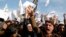 FILE - In a protest earlier this year at Afghanistan's Nangarhar University, students chant slogans critical of the satirical French weekly Charlie Hebdo, which had featured a cartoon of the Prophet Muhammad on its cover, Jan. 18, 2015.