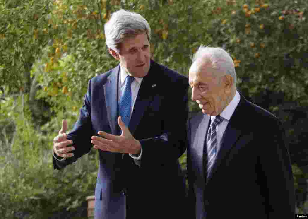 Presiden Israel Shimon Peres (kanan) dan Menteri Luar Negeri AS John Kerry berbincang dalam pertemuan di Yerusalem (8/4).