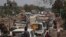 FILE - This photo provided by Nabaa Media, a Syrian opposition media outlet, shows people in their vehicles fleeing from Daraa, southern Syria, June 28, 2018. 