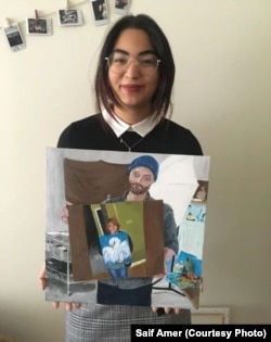 Laila Amer holds her painting.