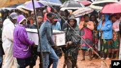 FILE - Pallbearers carry a coffin at the burial ceremony for some of the people who lost their lives following heavy rains caused by Cyclone Freddy in Blantyre, southern Malawi, Wednesday, March 15, 2023.