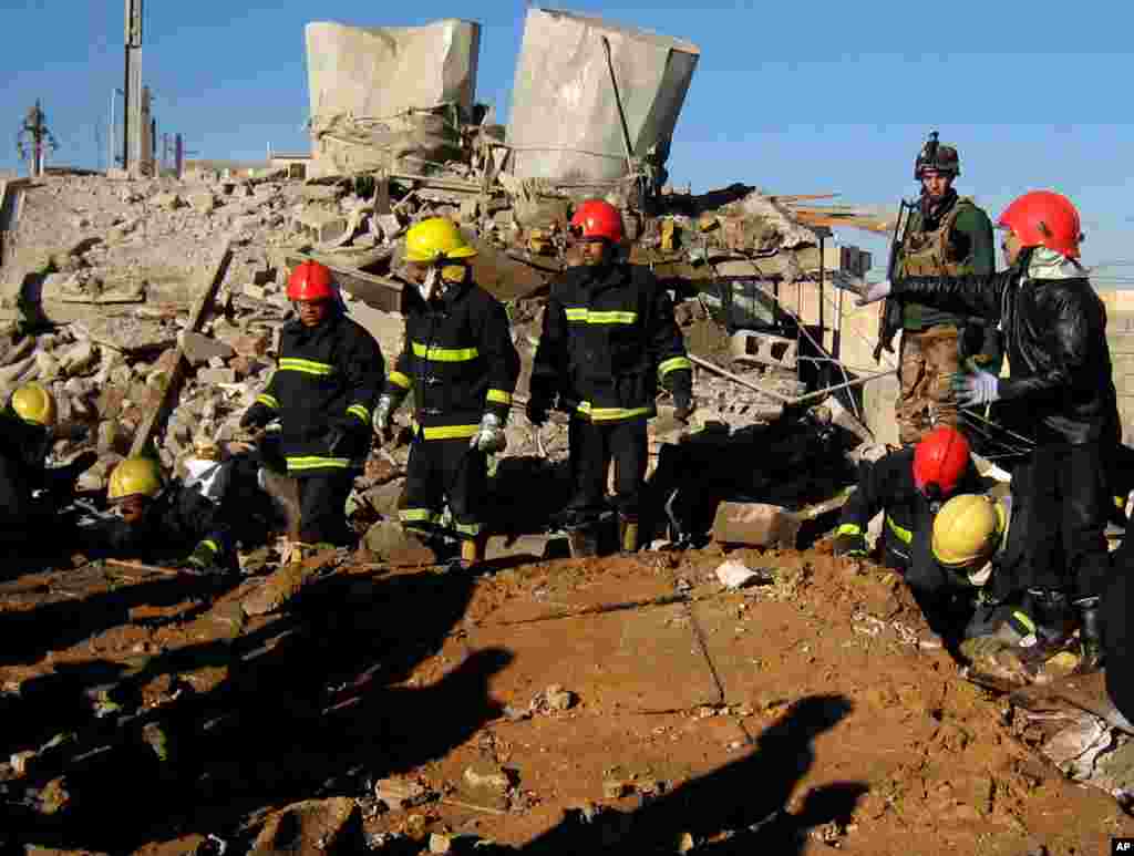 Firefighters look for survivors at the local headquarters of the Kurdistan Democratic Party after a bomb attack in Kirkuk, Iraq, January 16, 2013.