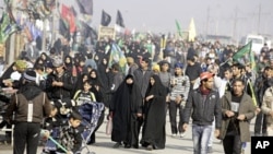 Shiite pilgrims march on their way to Karbala for Arbaeen in Baghdad, Iraq, January 9, 2012