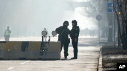 Police block the road to control the traffic in Almaty, Kazakhstan, Jan. 12, 2022. 