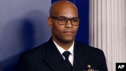 FILE - In this March 22, 2020, file photo U.S. Surgeon General Jerome Adams attends a coronavirus task force briefing at the White House, in Washington. Chicago is among several large American cities identified as hot spots for COVID-19 infections…