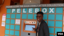 Inventor Neo Hutiri poses in front of one of his Peleboxes. (T. Khumalo/VOA)