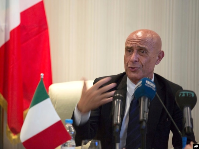 FILE - Italian Interior Minister Marco Minniti speaks during a meeting with Libyan Interior Minister Al-Arif Saleh Al-Khoja and the mayors of Libyan municipalities, to discuss the problem they face with migrants attempting to cross the Mediterranean Sea, July 13