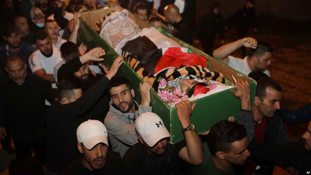 Muslim men carry the body of Iyad Halak to burial after Israeli police shot him dead in Jerusalem's old city, May 31, 2020. 