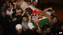 Muslim men carry the body of Iyad Halak to burial after Israeli police shot him dead in Jerusalem's old city, May 31, 2020. 