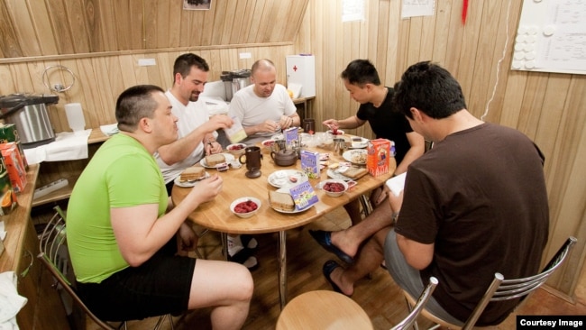The Mars500 crew is shown having breakfast together inside one of the facility’s modules. (European Space Agency/Institute for Biomedical Problems)