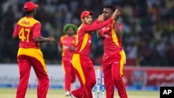 FILE: Zimbabwe players celebrate the dismissal of Pakistan's Ahmed Shahzad during a match at the Gaddafi Stadium in Lahore, Pakistan, Sunday, May 24, 2015. The Twenty20 matches Friday and Sunday mark a return of international cricket to Pakistan for the first time since gunmen attacked buses carrying the Sri Lankan cricket team and match officials in this eastern city six years ago. Security has been beefed up for the matches. (AP Photo/B.K. Bangash)
