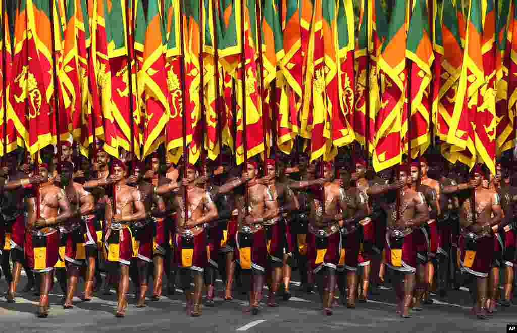 Tentara Sri Lanka mengenakan kostum tradisional membawa bendera nasional selama perayaan Hari Kemerdekaan di Kolombo, Sri Lanka. (Foto: AP)