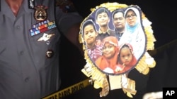 Surabaya Police Chief Col. Rudi Setiawan shows a picture of the family of Dita Oepriarto who carried out the church attacks on May 13, 2018 in Surabaya, East Java, Indonesia.