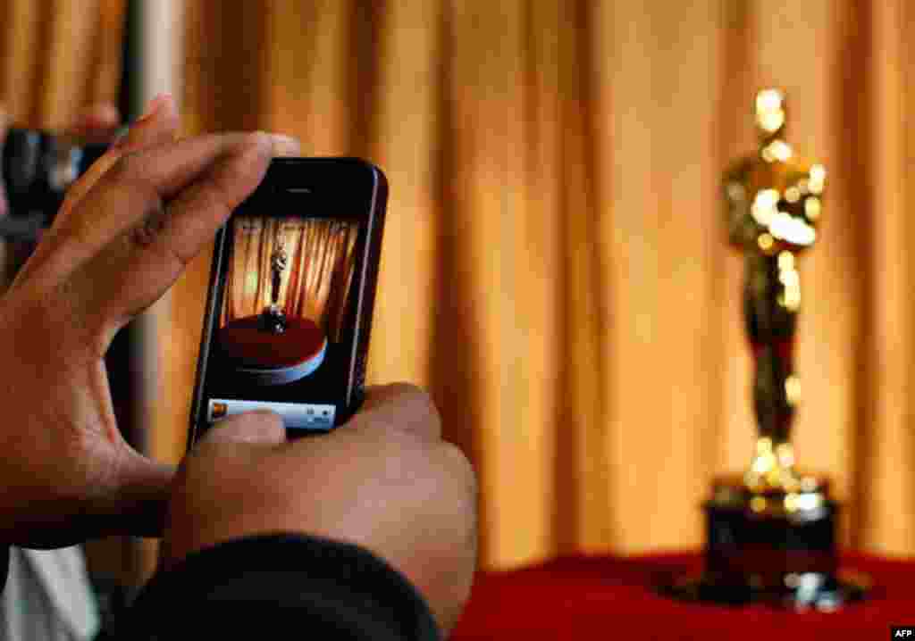 A man photographs an Oscar statuette using his phone at the "Meet the Oscars" exhibit at Grand Central Station in New York. The 83rd Annual Academy Awards are scheduled to take place in Los Angeles on February 27. (Reuters/Brendan McDermid)