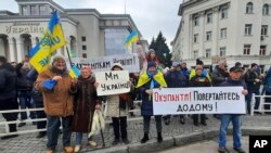 People hold Ukrainian flags and banners during a rally against the Russian occupation in Svobody (Freedom) Square in Kherson, Ukraine. (File)