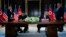 President Donald Trump and North Korean leader Kim Jong Un participate in a signing ceremony during a meeting on Sentosa Island, June 12, 2018, in Singapore. 