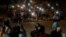 Residents flash the lights from their mobile phones during an anti-coup rally held despite an overnight curfew at the Myaynigone area of Sanchaung township in Yangon, Myanmar Monday, March 15, 2021. Myanmar's ruling junta has declared martial law in…