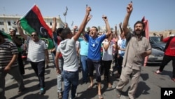 Libyans hold up their ink-marked fingers that shows they have voted as they celebrate in Martyrs' Square in Tripoli, July 7, 2012. 