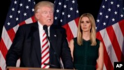 FILE - Ivanka Trump, right, looks on as her father, Donald Trump, delivers a policy speech on child care.