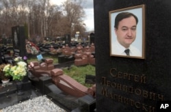 FILE - A tombstone on the grave of lawyer Sergei Magnitsky who died in jail, at a cemetery in Moscow, Nov. 16, 2012.