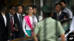 Aung San Suu Kyi (tengah) saat tiba di bandara internasional Beijing, Rabu (10/6).