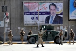 Afghan security forces work at the site of a suicide attack near the U.S. Embassy in Kabul, Afghanistan, Sept. 17, 2019.