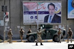 Afghan security forces work at the site of a suicide attack near the U.S. Embassy in Kabul, Afghanistan, Sept. 17, 2019.