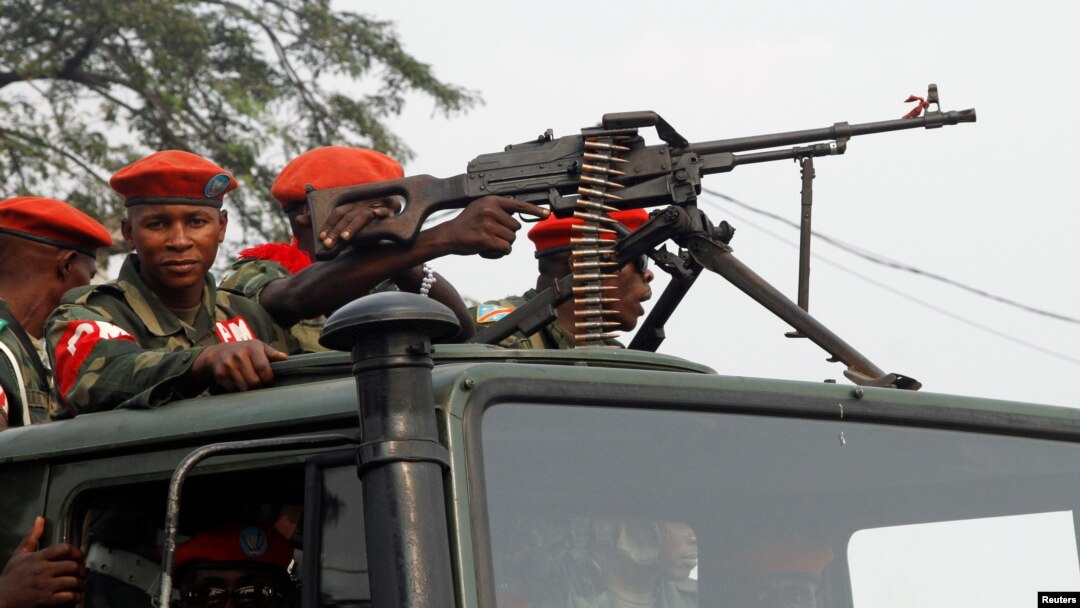FILE - Military police officers ride on a truck as they patrol the streets of Kinshasa, Democratic Republic of the Congo, June 29, 2017. 