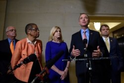 House Intelligence Committee Chairman Adam Schiff, D-Calif., second from right, talks with reporters on Capitol Hill in Washington, Nov. 6, 2019, about the House impeachment inquiry.