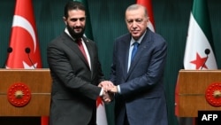 Syria's interim President Ahmed al-Sharaa, left, and Turkish President Recep Tayyip Erdogan shake hands during a press conference after their meeting at the Presidential Palace in Ankara, Turkey, Feb. 4, 2025.