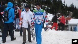 Snowboard cross athlete Pierre Vaultier of France walks next to hay bales covered partially with snow at Cypress Mountain, 15 Feb. 2010